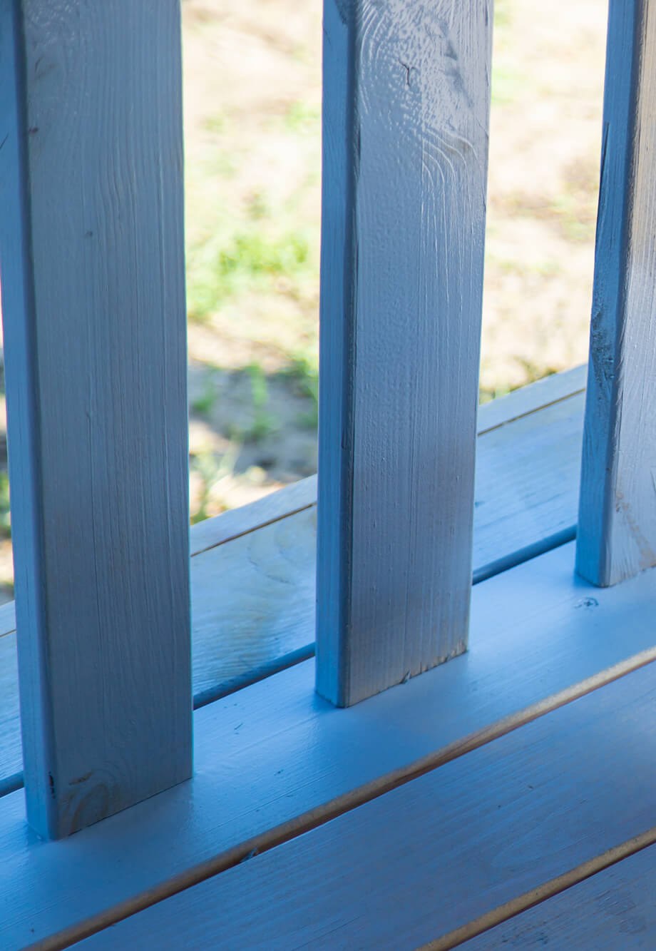 Fence slats and deck boards finished in a blue gray