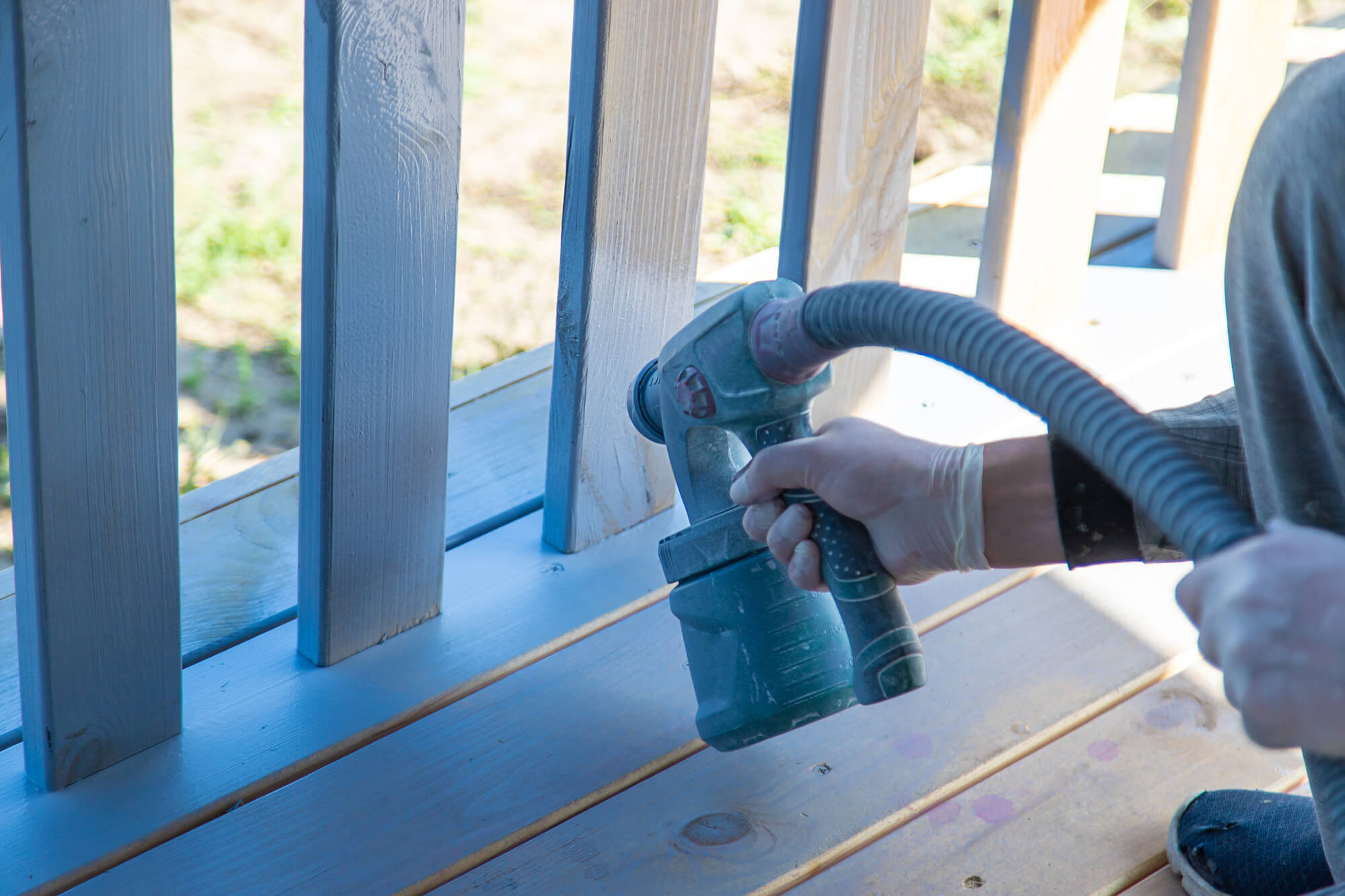 Spraying a slatted timber fence with an HVLP gun