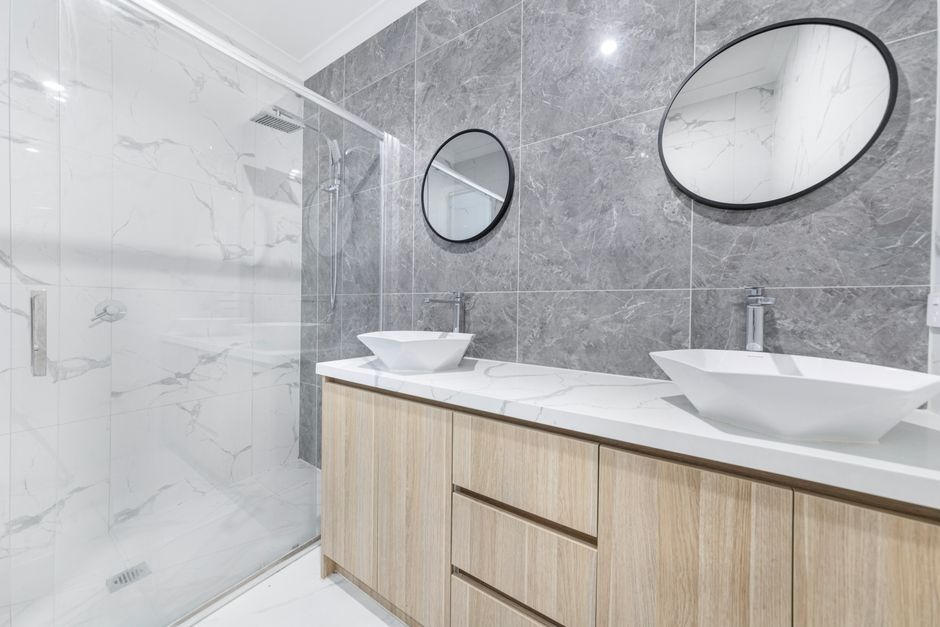 Bathroom with twin basins and round mirrors
