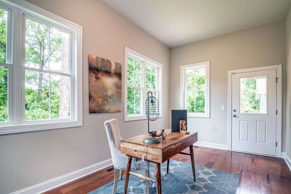 Light room with a table set against tall windows