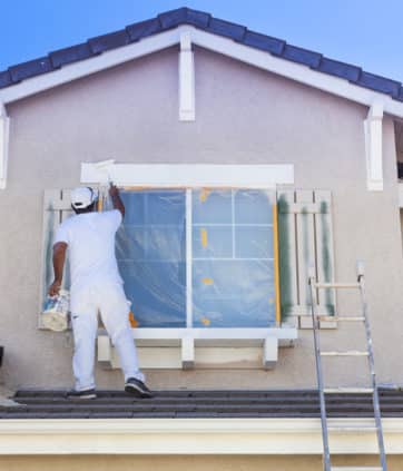 Busy House Painter Painting the Trim And Shutters of A Home - Big Easy Paintings