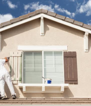 Professional House Painter Painting the Trim And Shutters of A Home - Big Easy Paintings
