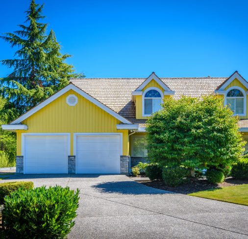House exterior is painted yellow and white.
