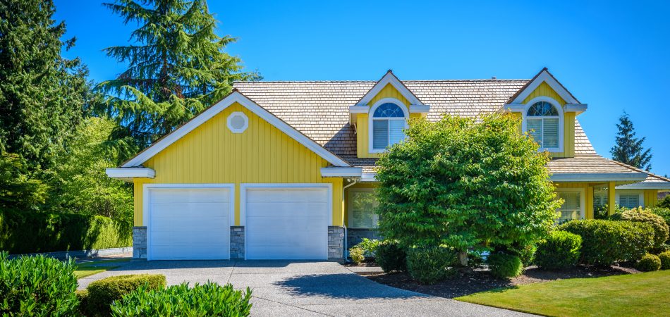 House exterior is painted yellow and white.